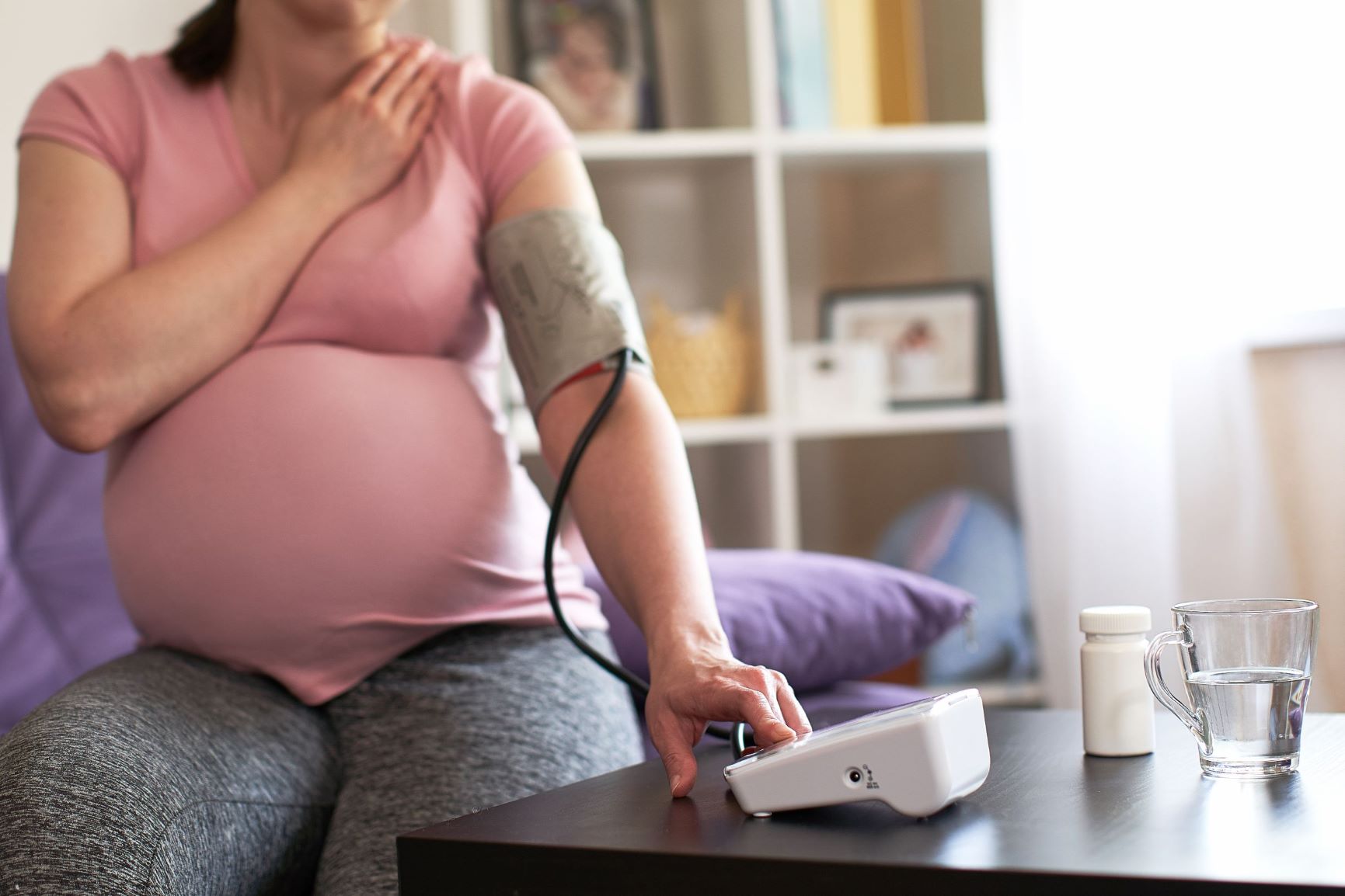 pregnant woman checks her blood pressure