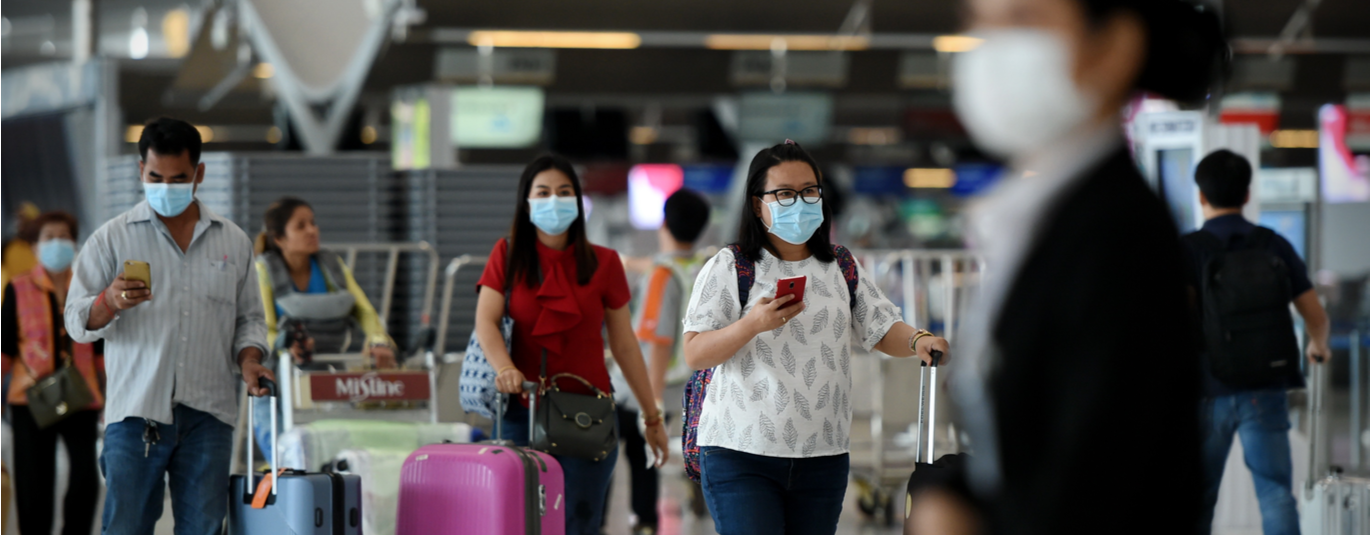 Travelers wearing masks in airport